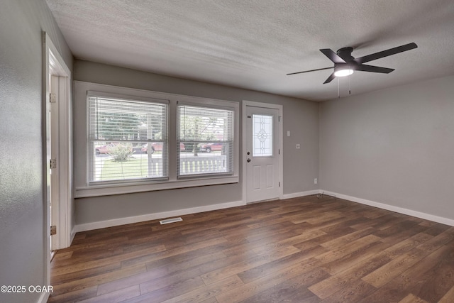 605 S Jefferson St, Webb City, MO 64870 - unfurnished room featuring wood finished floors, a textured ceiling, plenty of natural light, and a ceiling fan