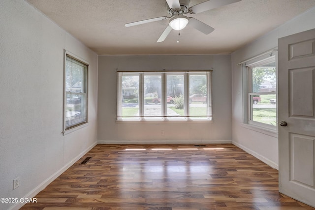 605 S Jefferson St, Webb City, MO 64870 - unfurnished room with wood finished floors, a textured ceiling, ceiling fan, and a textured wall