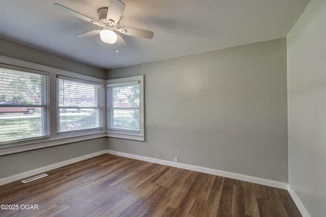 605 S Jefferson St, Webb City, MO 64870 - empty room with dark wood-style floors and a ceiling fan