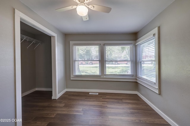 605 S Jefferson St, Webb City, MO 64870 - unfurnished bedroom featuring multiple windows, dark wood-style floors, and a closet