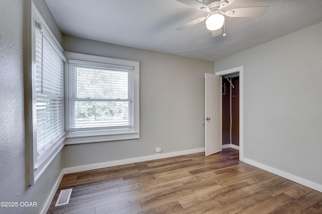 605 S Jefferson St, Webb City, MO 64870 - unfurnished bedroom with wood finished floors and a ceiling fan