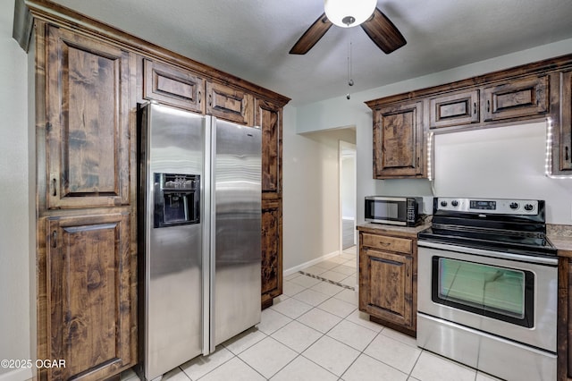 605 S Jefferson St, Webb City, MO 64870 - kitchen with appliances with stainless steel finishes, ceiling fan, and light tile patterned flooring