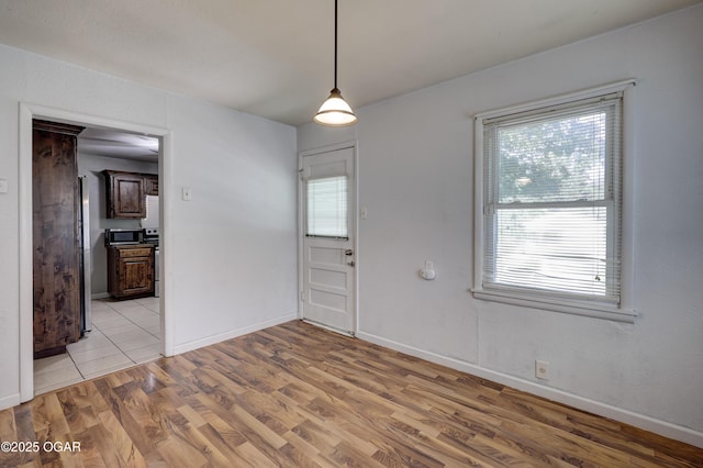 605 S Jefferson St, Webb City, MO 64870 - unfurnished dining area featuring light wood-type flooring and baseboards