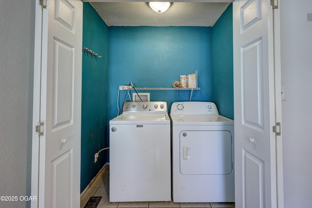 605 S Jefferson St, Webb City, MO 64870 - laundry room with washing machine and clothes dryer, light tile patterned floors, and a textured ceiling