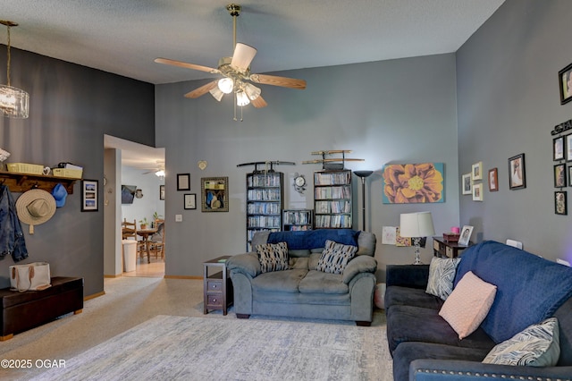 1501 Ryan Rd, Joplin, MO 64801 - carpeted living room with a towering ceiling, a ceiling fan, and a chandelier
