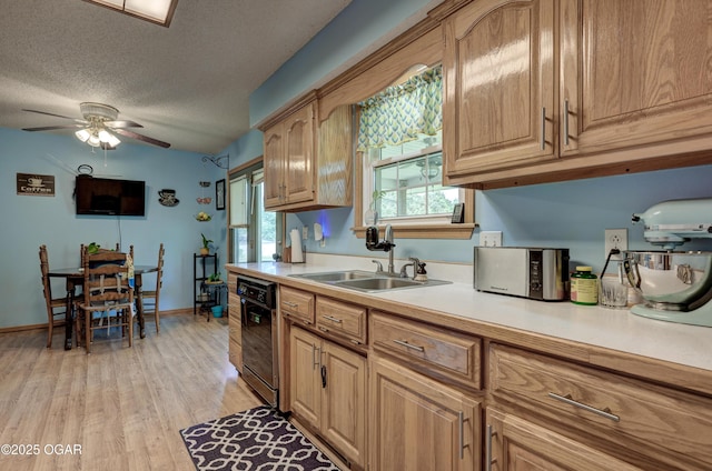 1501 Ryan Rd, Joplin, MO 64801 - kitchen with dishwasher, light countertops, light wood-type flooring, a ceiling fan, and a textured ceiling