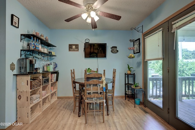 1501 Ryan Rd, Joplin, MO 64801 - dining room with light wood finished floors, a textured ceiling, and ceiling fan