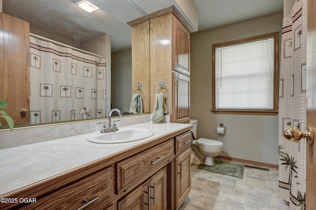 1501 Ryan Rd, Joplin, MO 64801 - bathroom with vanity, a textured ceiling, and stone finish floors