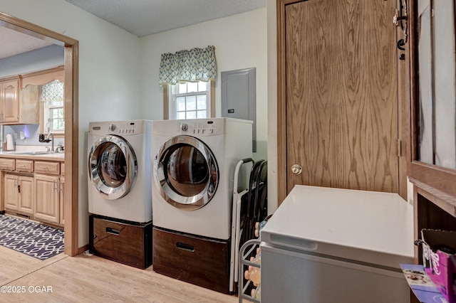 1501 Ryan Rd, Joplin, MO 64801 - washroom with washing machine and clothes dryer, light wood-style floors, and plenty of natural light