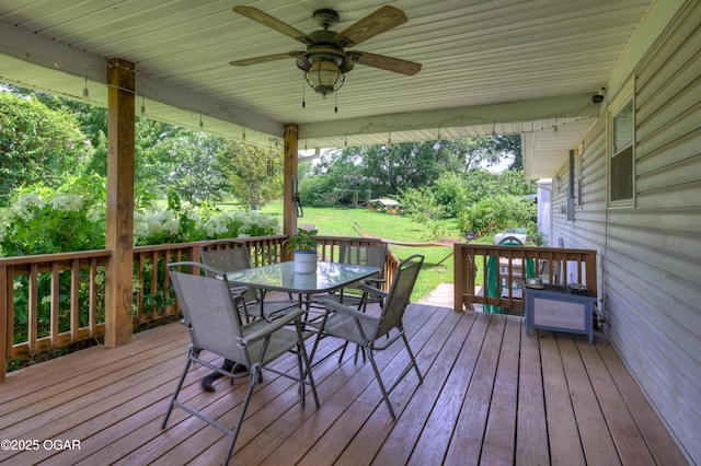 1501 Ryan Rd, Joplin, MO 64801 - wooden terrace featuring outdoor dining area, ceiling fan, and a yard