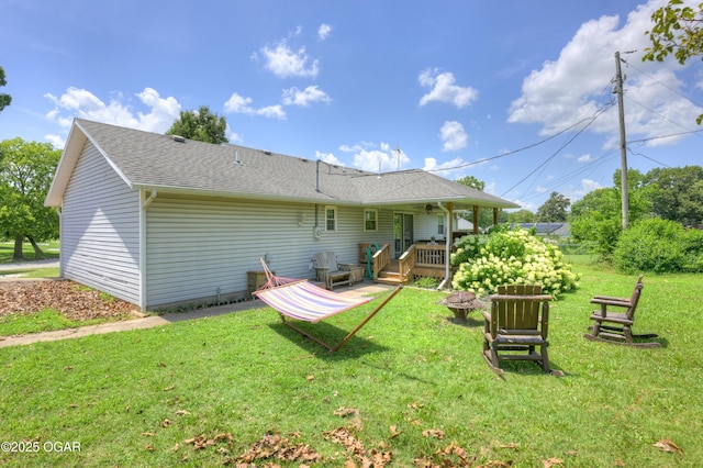 1501 Ryan Rd, Joplin, MO 64801 - rear view of property with a deck, a lawn, an outdoor fire pit, and a shingled roof
