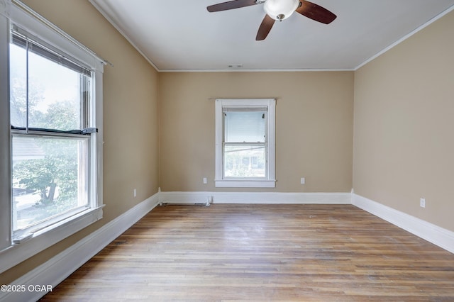 119 S Moffet Ave, Joplin, MO 64801 - empty room featuring healthy amount of natural light, crown molding, ceiling fan, and wood finished floors