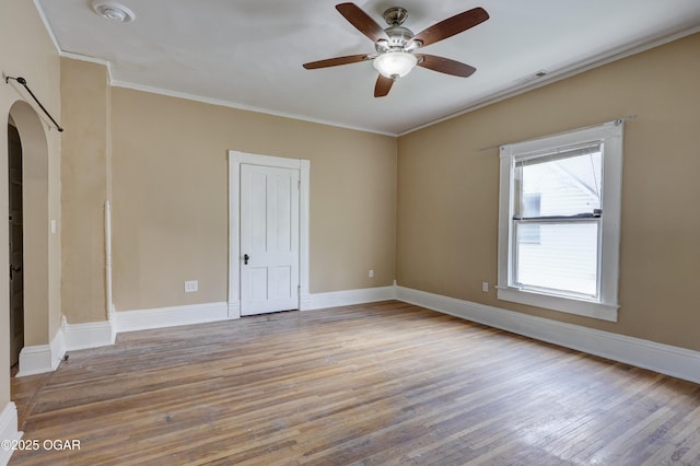 119 S Moffet Ave, Joplin, MO 64801 - unfurnished room featuring wood finished floors, arched walkways, ornamental molding, a ceiling fan, and a smoke detector