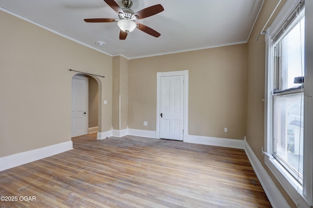 119 S Moffet Ave, Joplin, MO 64801 - spare room with healthy amount of natural light, light wood-type flooring, arched walkways, ceiling fan, and crown molding