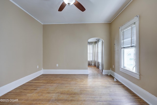 119 S Moffet Ave, Joplin, MO 64801 - unfurnished room featuring a ceiling fan, ornamental molding, light wood-type flooring, and arched walkways