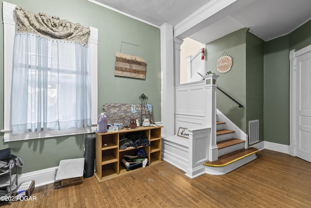 119 S Moffet Ave, Joplin, MO 64801 - bar featuring ornamental molding, wood finished floors, and stairs
