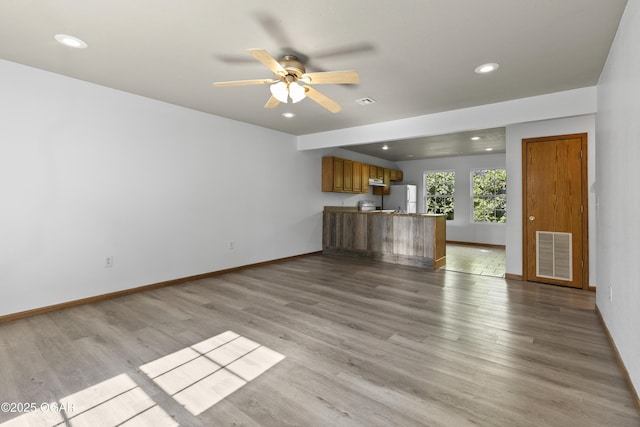 418 W Mccord St, Neosho, MO 64850 - unfurnished living room with ceiling fan, light wood-style floors, and recessed lighting