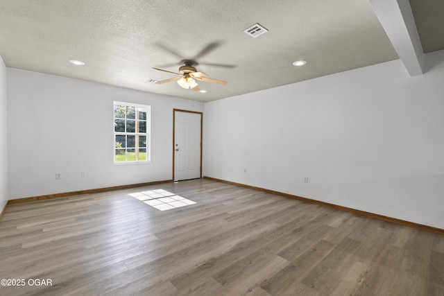 418 W Mccord St, Neosho, MO 64850 - spare room with ceiling fan, light wood finished floors, recessed lighting, and a textured ceiling