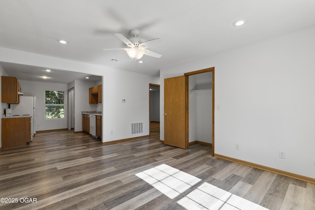 418 W Mccord St, Neosho, MO 64850 - unfurnished living room with wood finished floors, ceiling fan, and recessed lighting