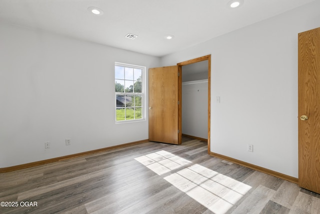418 W Mccord St, Neosho, MO 64850 - unfurnished bedroom featuring light wood-style flooring and recessed lighting