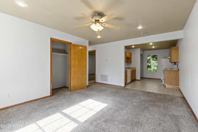 418 W Mccord St, Neosho, MO 64850 - unfurnished living room with light carpet, a ceiling fan, and recessed lighting