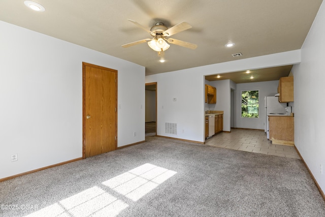 418 W Mccord St, Neosho, MO 64850 - unfurnished living room with light carpet, a ceiling fan, and recessed lighting