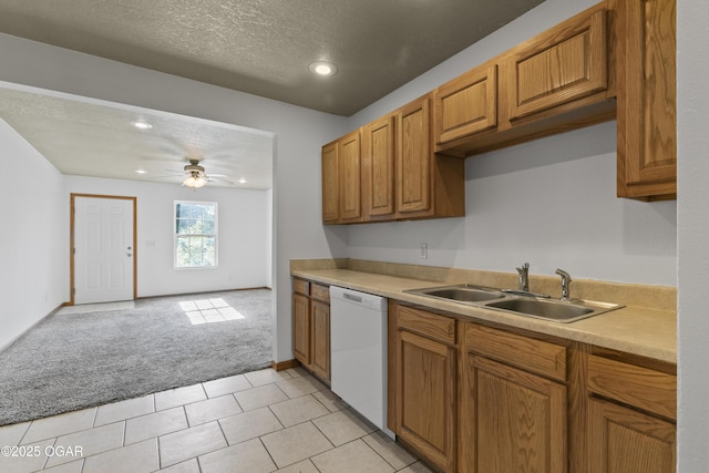 418 W Mccord St, Neosho, MO 64850 - kitchen featuring white dishwasher, light colored carpet, brown cabinetry, light countertops, and ceiling fan