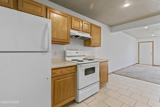 418 W Mccord St, Neosho, MO 64850 - kitchen with white appliances, under cabinet range hood, light countertops, recessed lighting, and brown cabinets