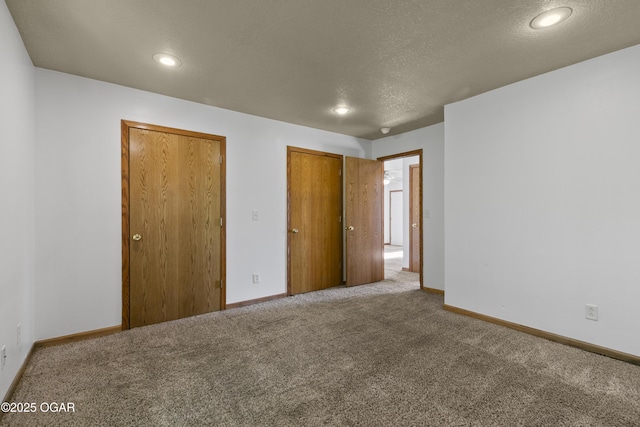 418 W Mccord St, Neosho, MO 64850 - unfurnished bedroom with carpet, a textured ceiling, and recessed lighting