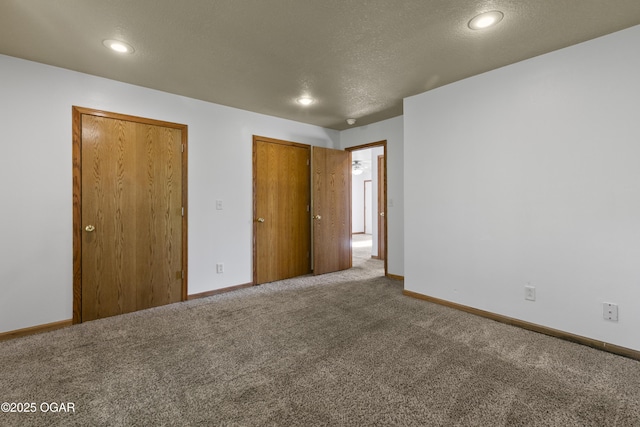 418 W Mccord St, Neosho, MO 64850 - unfurnished bedroom with a textured ceiling, carpet floors, recessed lighting, and a closet