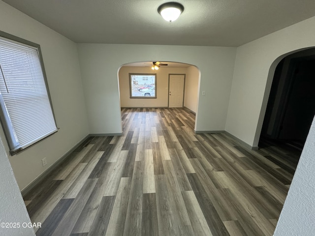 1003 Orchard St, Carthage, MO 64836 - spare room with arched walkways, wood finished floors, and ceiling fan