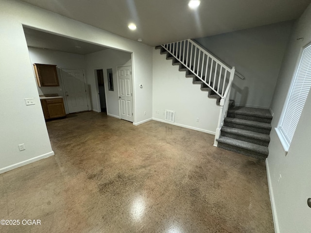 1003 Orchard St, Carthage, MO 64836 - unfurnished living room featuring stairs, recessed lighting, and plenty of natural light