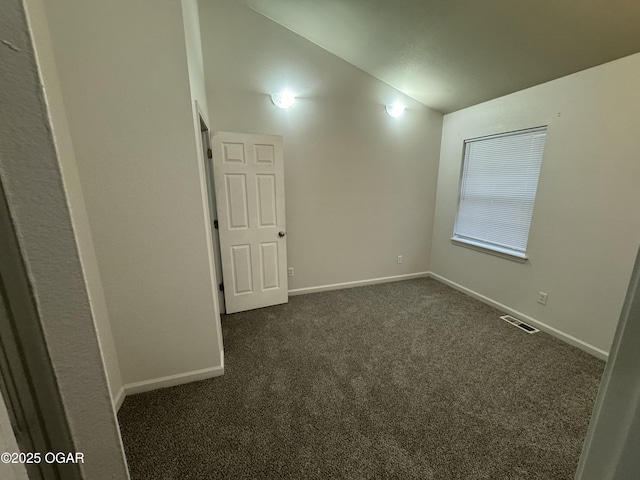 1003 Orchard St, Carthage, MO 64836 - empty room with vaulted ceiling and dark carpet