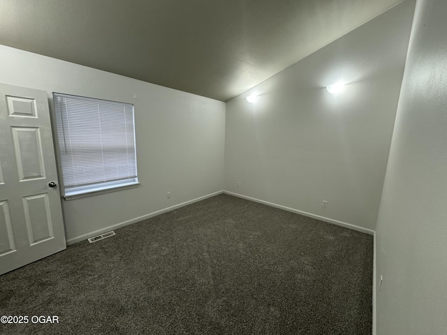 1003 Orchard St, Carthage, MO 64836 - empty room with vaulted ceiling and dark colored carpet