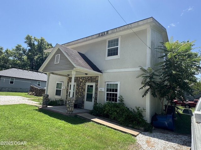 1003 Orchard St, Carthage, MO 64836 - view of front of property with a front yard, stucco siding, and stone siding