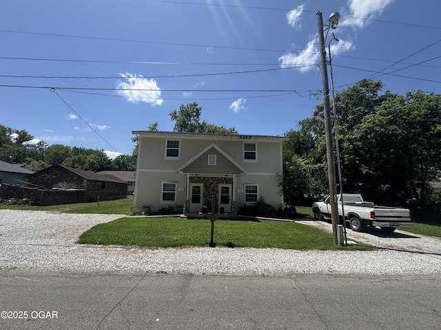 1003 Orchard St, Carthage, MO 64836 - view of front facade featuring a front yard and stucco siding