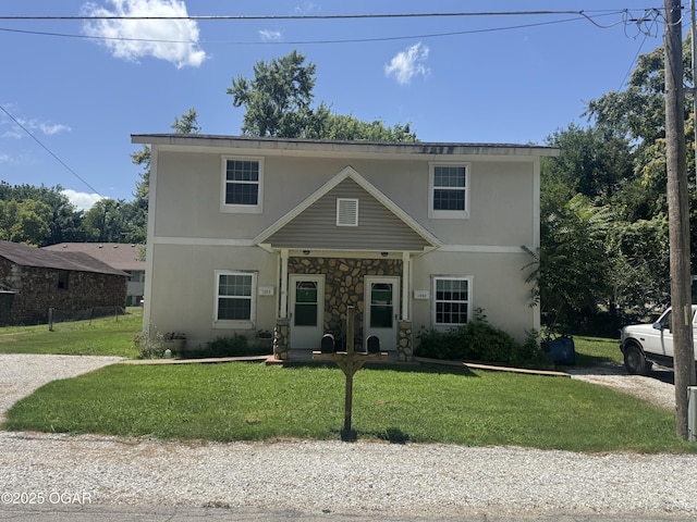 1003 Orchard St, Carthage, MO 64836 - traditional home featuring a front lawn and stucco siding