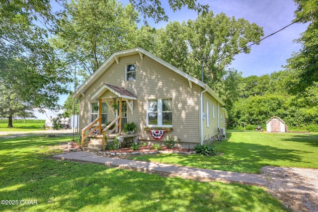 605 SE 10th Ln, Lamar, MO 64759 - view of front of home with a storage shed and a front lawn