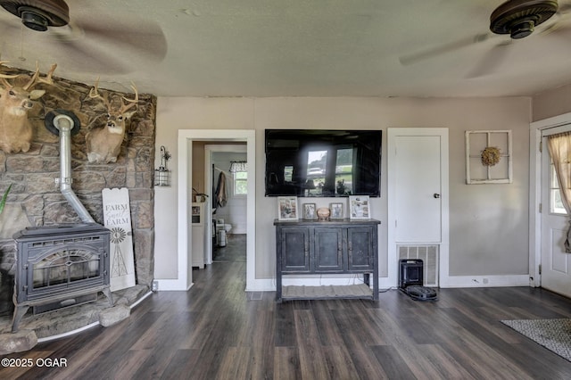 605 SE 10th Ln, Lamar, MO 64759 - living area with a wood stove, ceiling fan, and dark wood finished floors