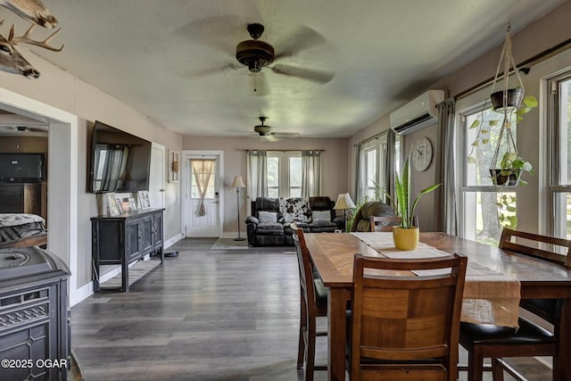 605 SE 10th Ln, Lamar, MO 64759 - dining area with a wall mounted AC, dark wood finished floors, and ceiling fan
