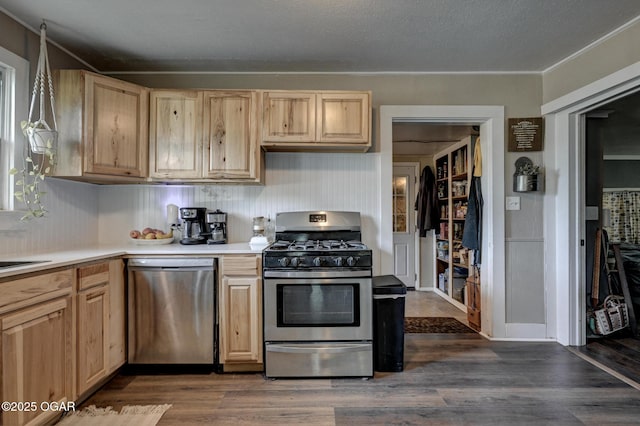 605 SE 10th Ln, Lamar, MO 64759 - kitchen featuring appliances with stainless steel finishes, light brown cabinets, light countertops, and dark wood finished floors