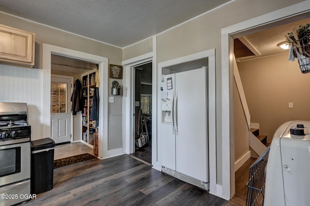 605 SE 10th Ln, Lamar, MO 64759 - kitchen with white fridge with ice dispenser, stainless steel range with gas cooktop, dark wood-style flooring, light brown cabinetry, and a textured ceiling