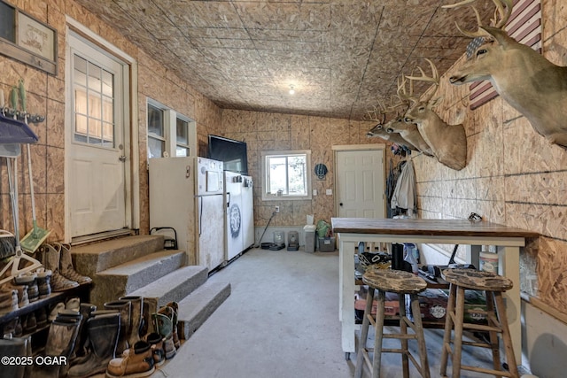 605 SE 10th Ln, Lamar, MO 64759 - kitchen featuring freestanding refrigerator and concrete flooring