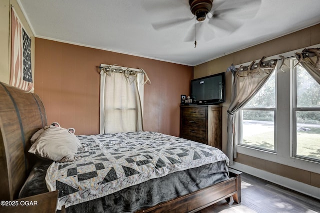 605 SE 10th Ln, Lamar, MO 64759 - bedroom featuring wood finished floors, ornamental molding, and ceiling fan