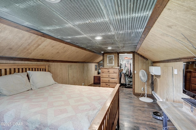 605 SE 10th Ln, Lamar, MO 64759 - bedroom with wooden walls, vaulted ceiling, wood finished floors, wood ceiling, and a walk in closet