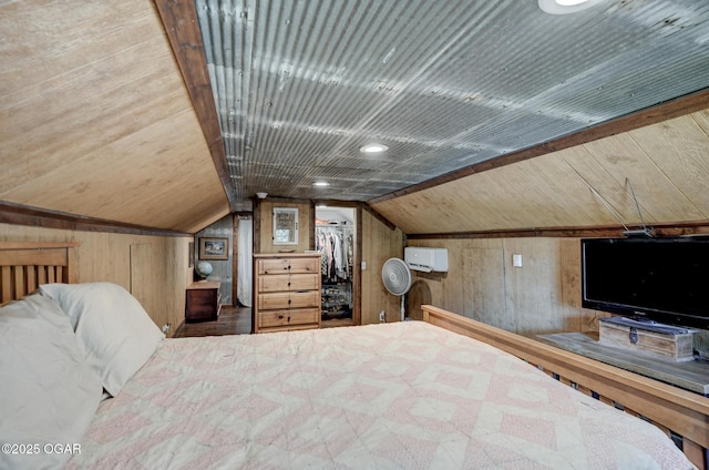 605 SE 10th Ln, Lamar, MO 64759 - bedroom featuring wooden walls, lofted ceiling, a spacious closet, a wall unit AC, and wooden ceiling