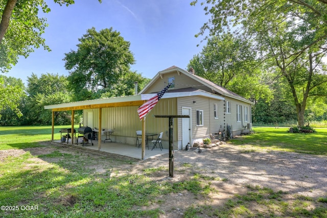 605 SE 10th Ln, Lamar, MO 64759 - back of house featuring a yard and a patio area