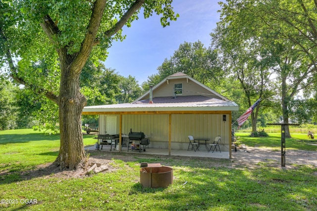 605 SE 10th Ln, Lamar, MO 64759 - back of property featuring a patio area, a yard, and board and batten siding