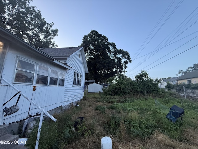 1222 Jersey St, Carthage, MO 64836 - view of side of home with roof with shingles