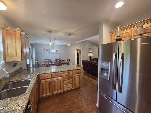3009 S Monroe Ave, Joplin, MO 64804 - kitchen featuring stainless steel refrigerator with ice dispenser, a peninsula, dark tile patterned floors, hanging light fixtures, and light stone countertops